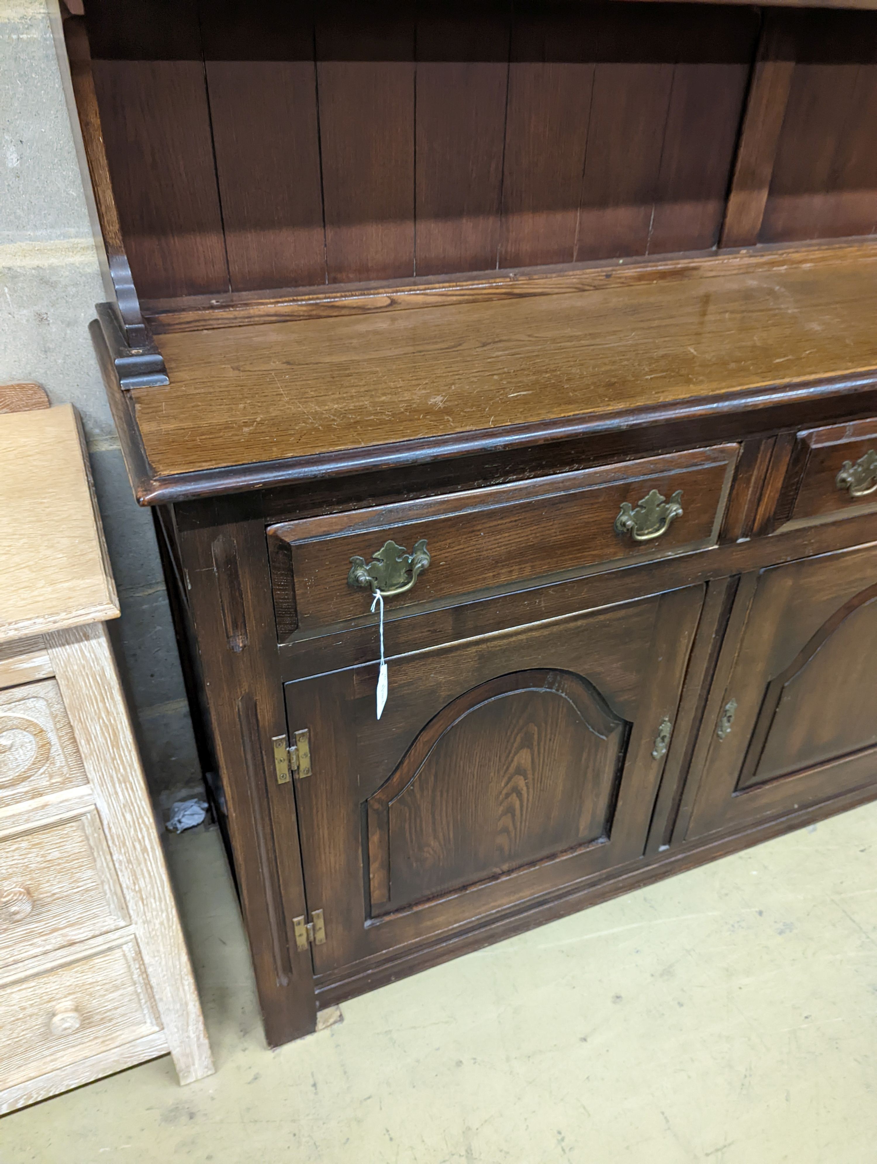 A Georgian style oak dresser base with boarded rack, W-184cm, D-46cm, H-188cm.